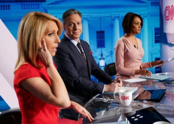 CNN news anchor Jake Tapper, flanked by Univision's news anchor Ilia Calderón, watches as co-anchor Dana Bash adjusts her ear piece before the start of the 11th Democratic Party 2020 presidential debate in a CNN Washington Bureau studio in Washington, D.C., on March 15, 2020.