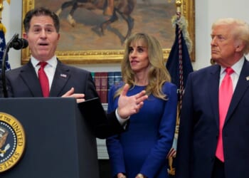 Tech billionaire Michael Dell speaks as his wife Susan Dell and President Donald Trump look on while making an announcement about "Trump accounts" in the Roosevelt Room at the White House on Dec. 2, 2025, in Washington, D.C.