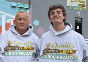 YouTuber Nick Shirley and the Minnesota fraud researcher known simply as "David" pose in "Quality Learing Center" sweatshirts outside the allegedly fraudulent facility in Minneapolis, Minnesota, on Dec. 30, 2025.