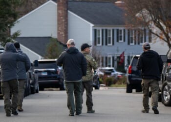FBI agents gather in front of the home of the suspected Jan. 6, 2021, pipe bomber on Dec. 4, 2025, in Woodbridge, Virginia.