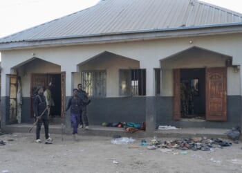 Members of the Civilian Joint Task Force stand at the scene of the explosion at a mosque in the Gamboru market in Maiduguri on Dec. 25, 2025.
