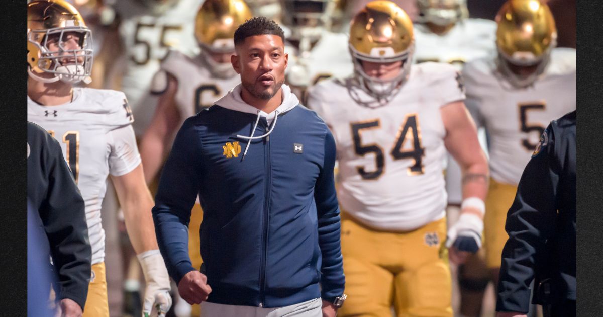 Head Coach Marcus Freeman of the Notre Dame Fighting Irish leads his team into the stadium Nov. 29 to start the second half of a college football game against the Stanford Cardinals in Palo Alto, California.