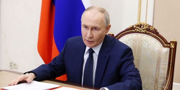 In this pool photograph distributed by the Russian state agency Sputnik, Russian President Vladimir Putin chairs a Security Council meeting via videolink in Moscow on Dec. 26, 2025.