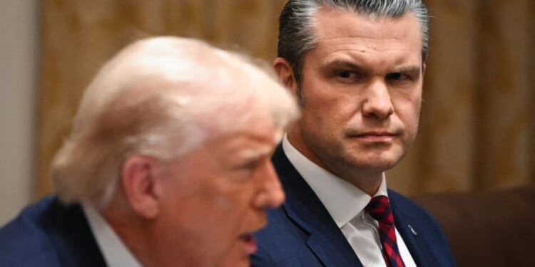President Donald Trump speaks alongside Secretary of War Pete Hegseth during a Cabinet meeting in the White House in Washington, D.C., on Dec. 2, 2025.