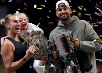 Runner-up Aryna Sabalenka and her goddaughter Nicole pose for a photo with Nick Kyrgios of Australia during the trophy ceremony following the Battle of the Sexes match between the two Sunday in Dubai, United Arab Emirates.