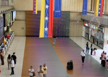 Travelers wait in the main hall of the Simon Bolivar Maiquetia International Airport in Maiquetia, Venezuela, on Nov. 23, 2025.