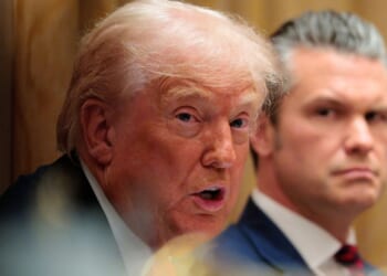 U.S. Secretary of War Pete Hegseth, right, looks on as President Donald Trump speaks during a meeting of his Cabinet Dec, 2 at the White House in Washington, D.C.