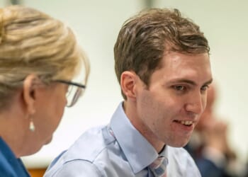 Tyler Robinson, the man accused of murdering conservative Charlie Kirk, shows a smile during a hearing in Provo, Utah, on Dec. 11, 2025.