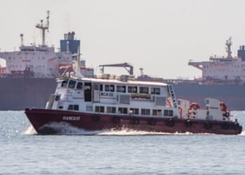 A boat sails in front of a crude oil tanker anchored on Lake Maracaibo near Maracaibo, Zulia state, Venezuela, on Dec. 18, 2025.