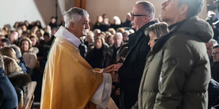 A mother says goodbye to her son as Swiss community grieves after deadly fire