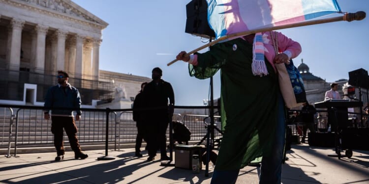 Women's sports activists celebrate after Supreme Court oral arguments