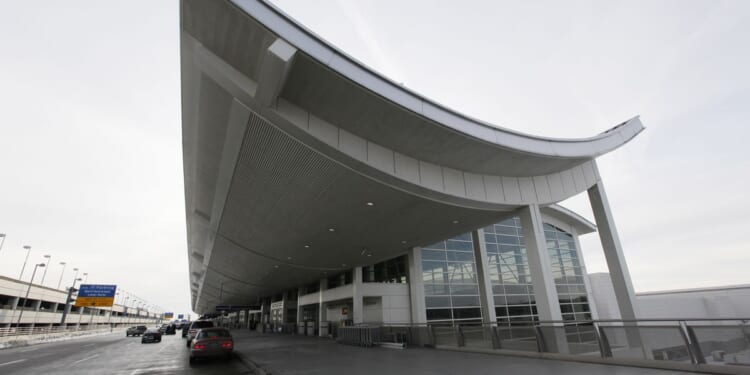 Car crashes through terminal entrance at Detroit airport, injuring 6