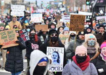 Protesters hold signs as they march from Powderhorn Park in Minneapolis against Immigration and Customs Enforcement and the fatal shooting of Renee Good by an ICE agent, calling on federal authorities to leave the city and demand accountability, in Minneapolis, Minnesota, on Jan. 10, 2026.