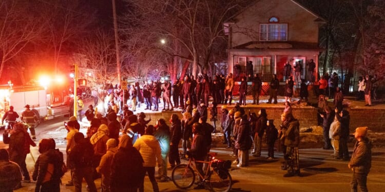 Residents confront federal agents following a shooting incident on Jan. 14, 2026, in Minneapolis, Minnesota.