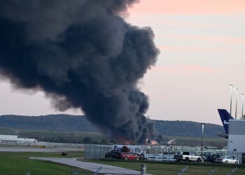 Fire and smoke mark where a UPS cargo plane crashed near Louisville Muhammad Ali International Airport on Nov. 4, 2025, in Louisville, Kentucky.