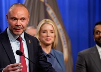 FBI Deputy Director Dan Bongino, accompanied by Attorney General Pam Bondi and FBI Director Kash Patel, speaks during a news conference on an arrest of a suspect in the Jan. 6 pipe bomber at the Department of Justice on Dec. 4, 2025, in Washington, D.C.
