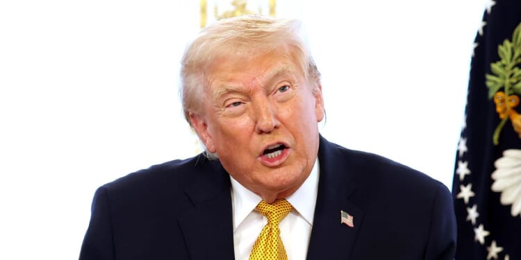 President Donald Trump calls service members on Christmas Eve at the Mar-a-Lago resort on Dec. 24, 2025, in Palm Beach, Florida.