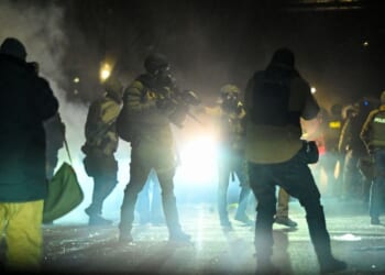Federal agents fire tear gas into a crowd of Minneapolis rioters amid unrest in Minneapolis, Minnesota, on Jan. 14, 2026.