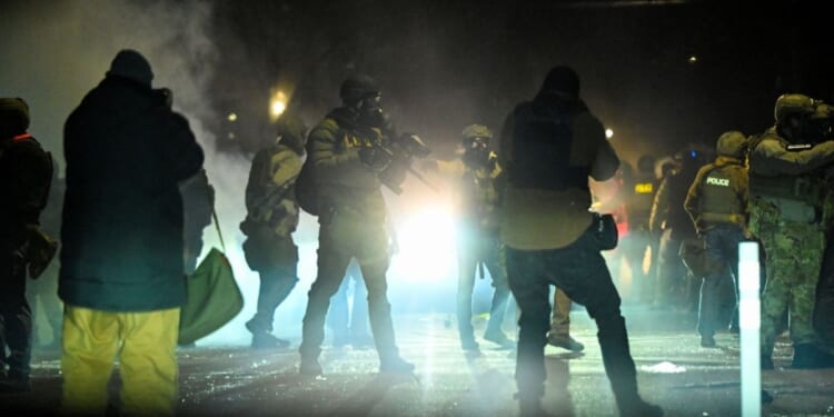 Federal agents fire tear gas into a crowd of Minneapolis rioters amid unrest in Minneapolis, Minnesota, on Jan. 14, 2026.