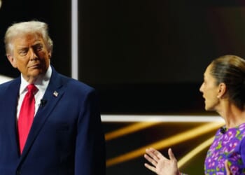 Mexican President Claudia Sheinbaum talks on stage next to President Donald Trump during the draw for the 2026 FIFA Football World Cup taking place in the U.S., Canada, and Mexico, at the Kennedy Center, in Washington, D.C., on Dec. 5, 2025.