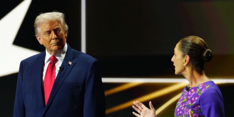 Mexican President Claudia Sheinbaum talks on stage next to President Donald Trump during the draw for the 2026 FIFA Football World Cup taking place in the U.S., Canada, and Mexico, at the Kennedy Center, in Washington, D.C., on Dec. 5, 2025.