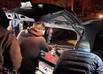 Minneapolis rioters held lights and cheered on their companion as he chopped his way into a gun safe with a hatchet.