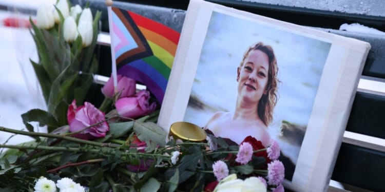 Flowers and candles are seen at a vigil for Renee Nicole Good in front of the United States embassy on Jan. 11, 2026, in Berlin, Germany.