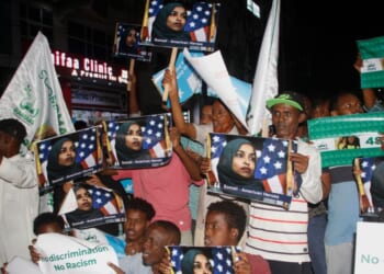 Protesters hold photos of U.S. Rep. Ilhan Omar up during a demonstration in Mogadishu, Somalia on Dec. 5, 2025.