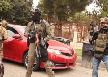 Border Patrol agents and other law enforcement ask a car to make room for a police vehicle to pass while investigating a shooting involving a federal agent on Wednesday morning in Willowbrook on Jan. 21, 2026.