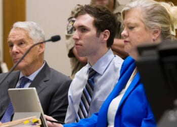 Tyler Robinson, center, accused in the fatal shooting of Charlie Kirk, appears during a hearing in 4th District Court on Jan. 16 in Provo, Utah. Prosecutors have charged Robinson with aggravated murder and plan to seek the death penalty.