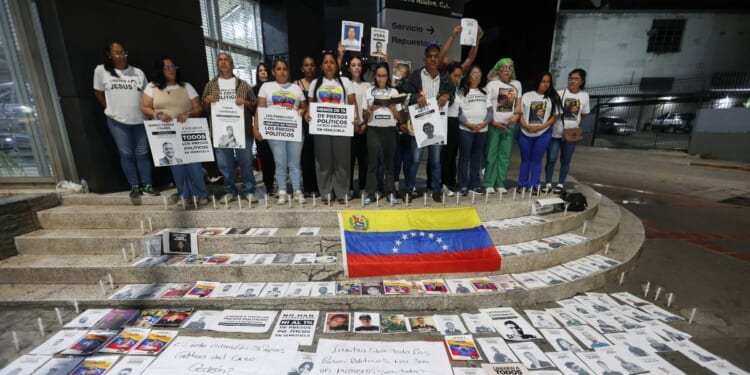 People attend a vigil to demand freedom for political prisoners at El Helicoide, a facility and prison owned by the Venezuelan government and used for both regular and political prisoners of the Bolivarian National Intelligence Service, in Caracas, Venezuela, on Jan. 13, 2026.