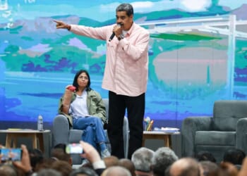 Then-Venezuelan President Nicolás Maduro, center, speaks next to Vice President Delcy Rodriguez, left, in a 2024 photo. Since Maduro's Saturday arrest, Rodriguez has issued orders to arrest those who supported the U.S. efforts to capture him.