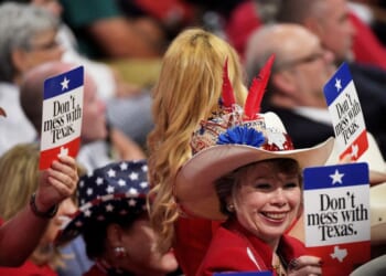 Delegates from Texas hold signs that read "Don't Mess with Texas" on the second day of the Republican National Convention on July 19, 2016, at the Quicken Loans Arena in Cleveland, Ohio.