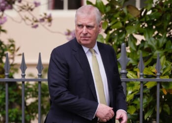 Activists hang arrest photo of former British Prince Andrew at Louvre
