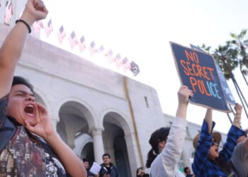 Teacher Andre Lopez, left, from Duarte Elementary School, joins activists and protesters take part in an "ICE Out of Everywhere" protest in front of City Hall in downtown Los Angeles on Jan. 30, 2026.