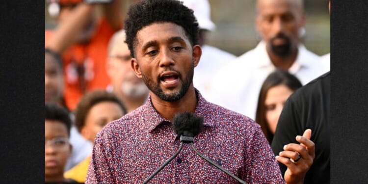 Baltimore Mayor Brandon Scott, left, speaks during a Sept. 5 news conference.