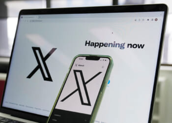 The opening page of X is displayed on a computer and phone on Oct. 16, 2023, in Sydney, Australia.