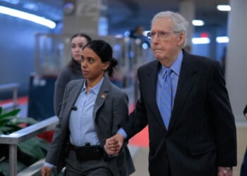 Sen. Mitch McConnell is assisted by U.S. Capitol Police as he heads for a vote on Jan. 14, 2026, in Washington, D.C.