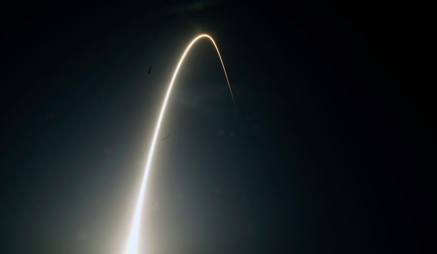 In this time-exposure photograph, a SpaceX Falcon 9 rocket with the 25th batch of approximately 60 satellites for SpaceX's Starlink broadband network lifts off from the Space Launch Complex 40 at the Cape Canaveral Space Force Station in Cape Canaveral, Fla., late Wednesday, April 28, 2021. (AP Photo/John Raoux, File)