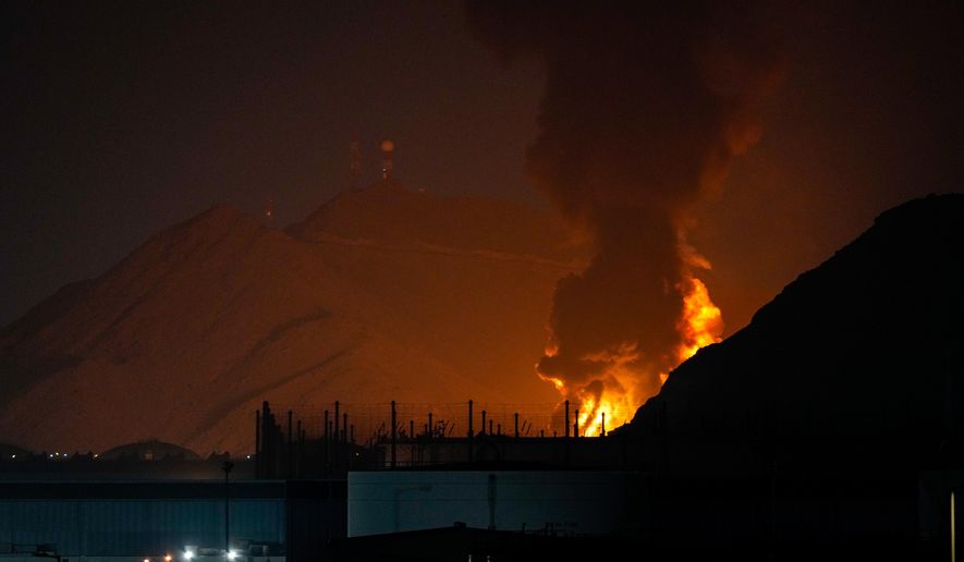 Large fire and plume of smoke is visible after, according to the authorities, debris of an Iranian intercepted drone hit the Fujairah oil facility, in Fujairah, United Arab Emirates, Tuesday, March 3, 2026. (AP Photo/Altaf Qadri)