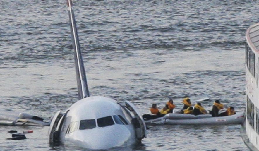 FILE - In this Jan. 15, 2009 file photo, passengers in an inflatable raft move away from US Airways Flight 1549 that went down in the Hudson River in New York. The jet ditched in the Hudson River after both engines failed when they ingested birds shortly after takeoff. All 155 people on board were safe; Captain Chesley Sullenberger and other crew members were hailed as heroes. (AP Photo/Bebeto Matthews, File)
