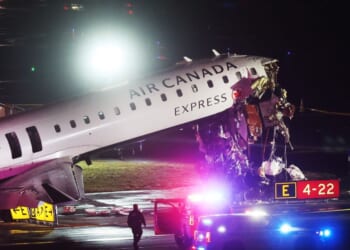 An Air Canada Express plane sits on the tarmac after a crash at LaGuardia Airport on March 23, 2026.