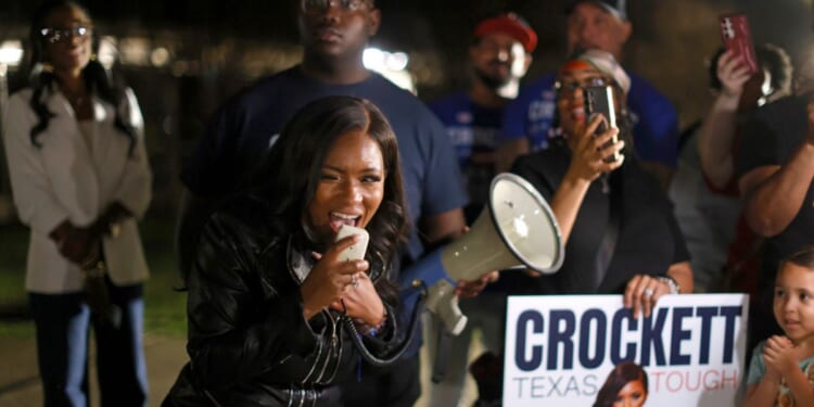 Rep. Jasmine Crockett speaks with supporters outside a polling station on Feb. 27, 2026, in Dallas, Texas.