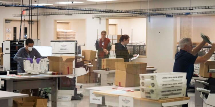 Election workers tabulate and adjudicate remaining ballots at the Maricopa County Tabulation and Election Center in Phoenix, Arizona, on Nov. 6, 2024.