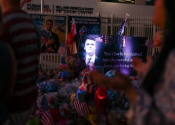 A large shrine made up of flowers, balloons, and U.S. flags displayed in honor of conservative Turning Point USA founder Charlie Kirk in Phoenix, Arizona, on Sept. 19, 2025.