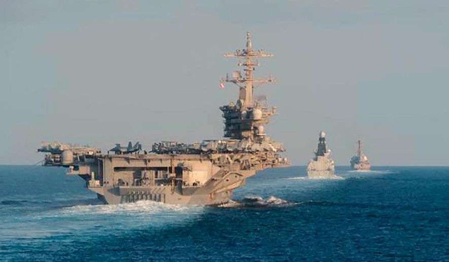 In this Nov. 19, 2019, file photo made available by U.S. Navy, the aircraft carrier USS Abraham Lincoln, left, the air-defense destroyer HMS Defender and the guided-missile destroyer USS Farragut transit the Strait of Hormuz with the guided-missile cruiser USS Leyte Gulf. (Mass Communication Specialist 3rd Class Zachary Pearson/U.S. Navy via AP) ** FILE **