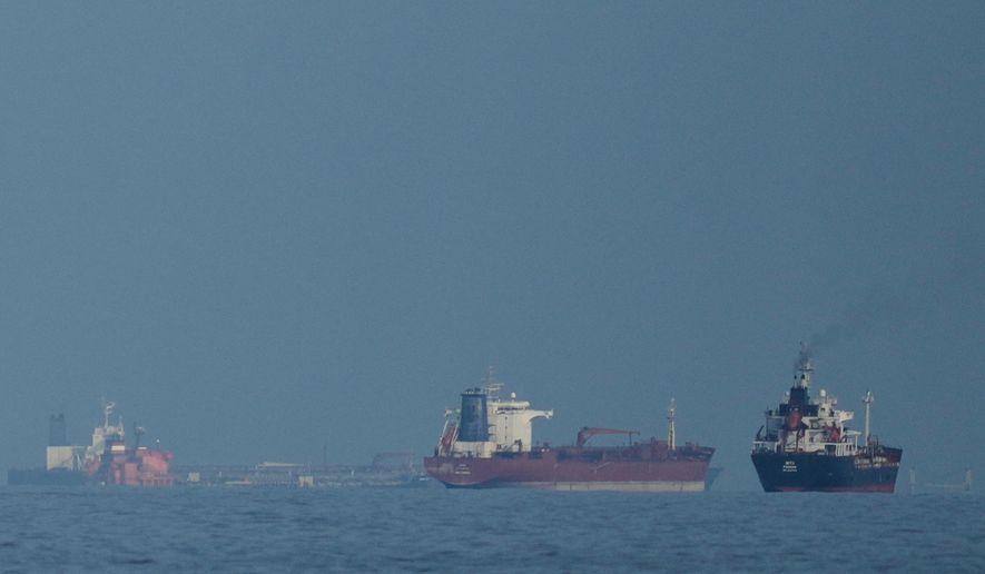 Oil tankers and cargo ships line up in the Strait of Hormuz as seen from Khor Fakkan, United Arab Emirates, Wednesday, March 11, 2026. (AP Photo/Altaf Qadri)