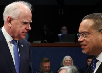 Minnesota Gov. Tim Walz speaks to Minnesota Attorney General Keith Ellison, right, as they arrive to testify during a House Oversight and Government Reform Committee hearing Wednesday in Washington, D.C. The committee held the hearing to examine the alleged misuse of federal funds intended for Minnesota social services and Medicaid programs.