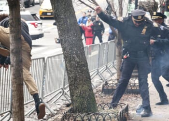 A left-wing activist flees the scene after throwing a homemade explosive device at anti-"Islamification" protesters in New York on March 7, 2026.