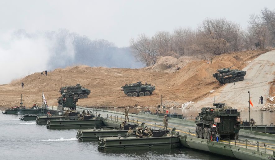 U.S. Army's armored vehicles cross a floating bridge on the Imjin River during a joint river-crossing exercise between South Korea and the United States as a part of the Freedom Shield military exercise in Yeoncheon, South Korea, Saturday, March 14, 2026. (AP Photo/Ahn Young-joon)